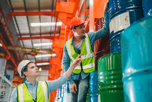Wallpaper Mural Engineers inspecting documents in heavy industrial warehouse surrounded by chemical barrels, ensuring safety protocols and operational accuracy in metalworking factory Torontodigital.ca