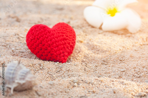 sweet heart on sand beach under sunset and warm light.