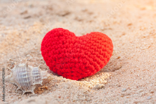 sweet heart on sand beach under sunset and warm light.