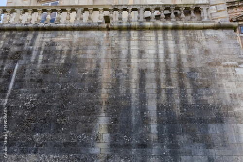 Wall of bastion clad with stone blocks with balustrade atop photo