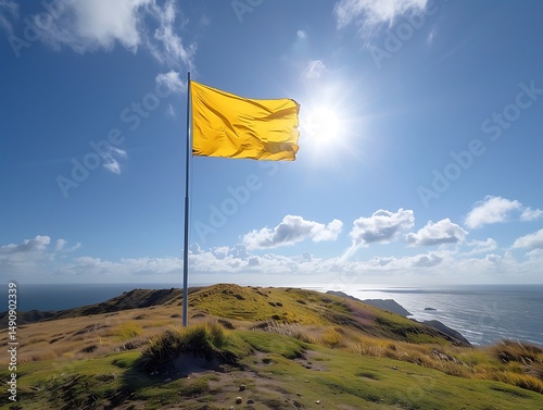 Bright yellow flag waving over a coastal hill
