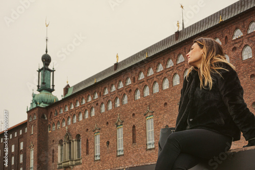 Photography A woman sitting in front of a famous building