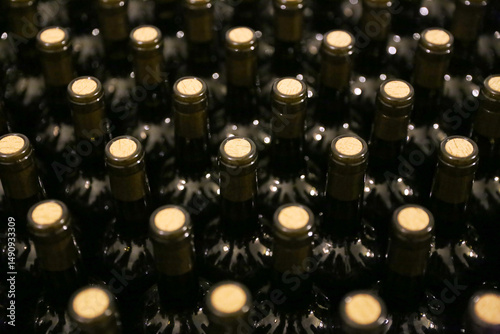 Bottles in a row at wine cellar. Stacked up wine bottles in the cellar