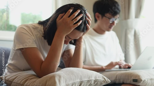 Slow motion scene technology and relationship problem, asian husband concentrate on working, social media, video game and ignore wife in living room, woman is annoyed bored about their communication 