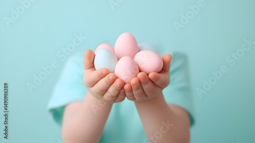 Child's Hands Holding Pastel Pink and Blue Easter Eggs