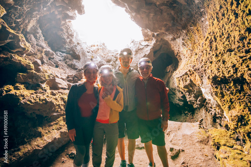Family exploring a lava cave wearing headlamps during an underground excursion