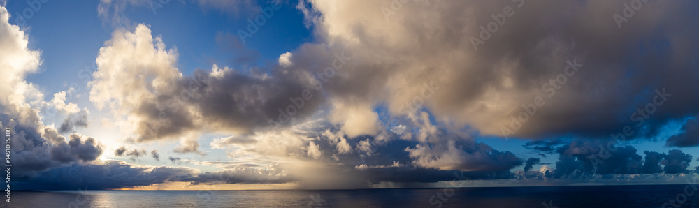 Fototapeta premium Dramatic Sunset Cloudscape Reflecting Over the Pacific Ocean Horizon