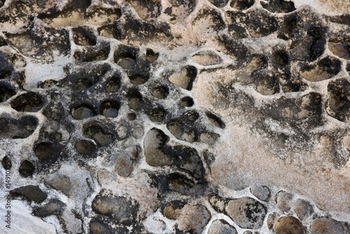 Close-up of cracked, textured surface resembling dried mud or stone. Natural pattern for abstract backgrounds, geology, nature textures, or design elements.