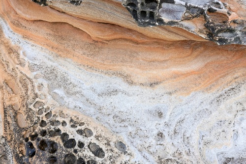 Natural sandstone texture with intricate layers, swirls, and patterns in warm earth tones. Perfect for backgrounds, design projects, geology, and nature-themed content.