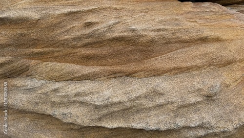 Natural sandstone texture with intricate layers, swirls, and patterns in warm earth tones. Perfect for backgrounds, design projects, geology, and nature-themed content.