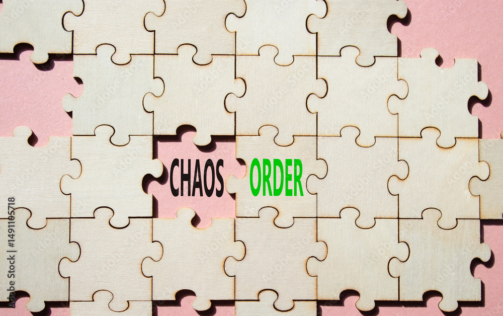 Fototapeta premium Chaos or Order symbol. Concept word Chaos or Order on wooden puzzle. Beautiful pink background. Business and Chaos or Order concept. Copy space