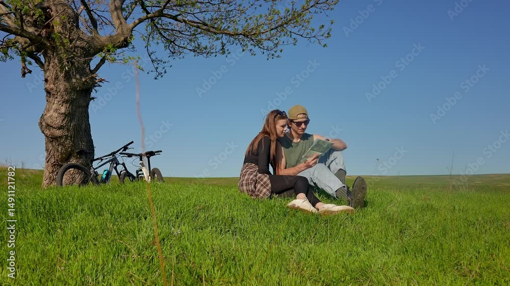 Couple Enjoying Outdoor Adventure with Bicycles and Map Couple Enjoying Outdoor Adventure with Bicycles and Map