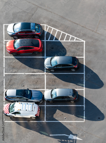 Parked cars in a parking lot, patterned on the asphalt in Schaerbeek, Brussels Capital Region, Belgium