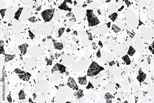 A detailed close up of a white and black terrazzo pattern with irregular shaped stone fragments