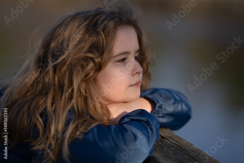 Teen face. Serenity and inspiration in a child eyes. Innocence and wonder captured in a portrait. Little dreamer portrait. Outdoor childhood moment. Blonde kid enjoying a peaceful outdoor moment.