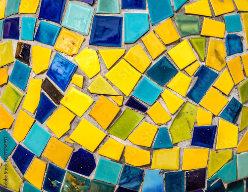 Vibrant mosaic tile background in blue, yellow, and green. Perfect for adding a pop of color and visual interest to any project, embodying creativity and fun.