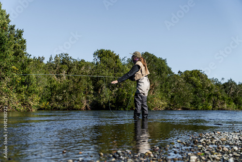 Side View of Woman Fly Fishing in a River