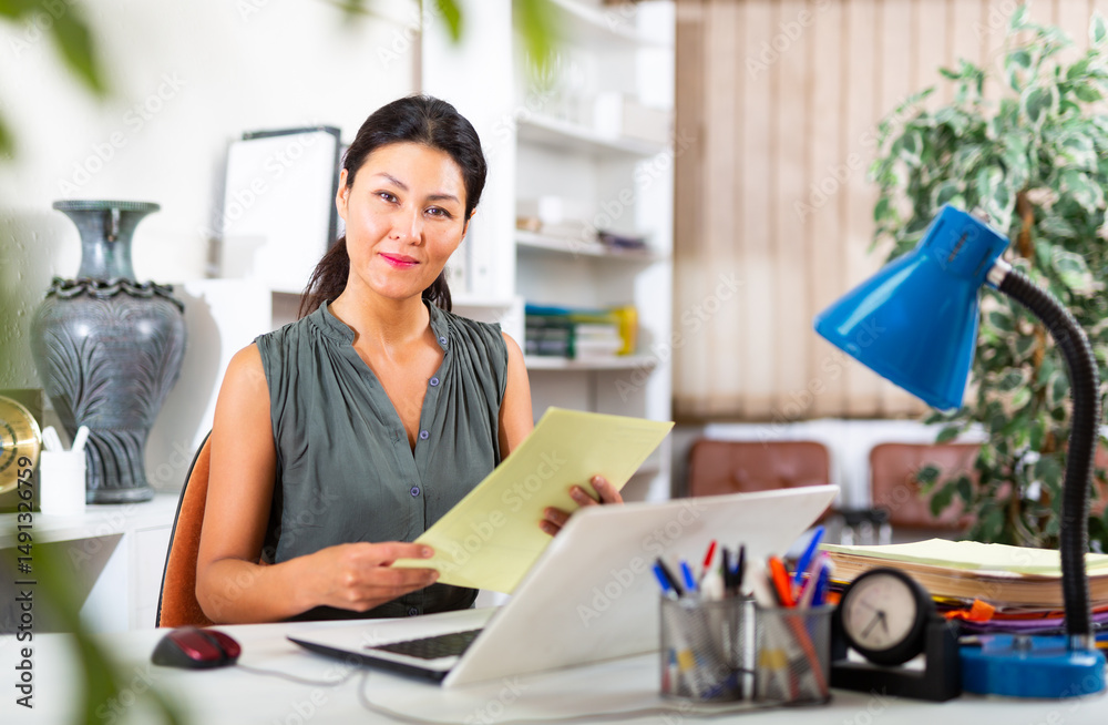 Business woman prepares and signs important documents in the office Business woman prepares and signs important documents in the office