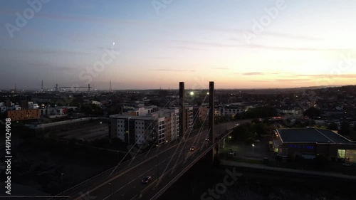 Wallpaper Mural  Evening low traffic on cable stayed bridge. Descending aerial footage of cars driving on road in city, twilight sky. Newport, Wales, UK Torontodigital.ca