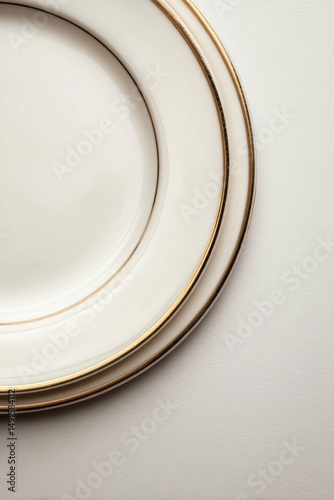 Elegant Ivory Plates with Gold Trim Stacked on Textured White Surface Close Up Studio Shot