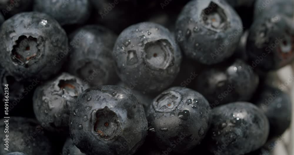 Macro photograph of fresh blueberries with visible water droplets, highlighting their texture and freshness. Ideal for food, health, and nature concepts. Fresh Blueberries with Water Droplets