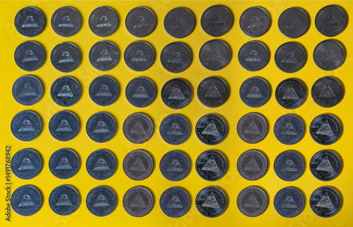 Many Nicaraguan coins on a yellow background. Several Nicaraguan coins on an isolated background