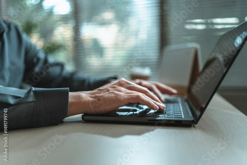 Businessman is hand working and typing on laptop. Business, corporate and finance concept.