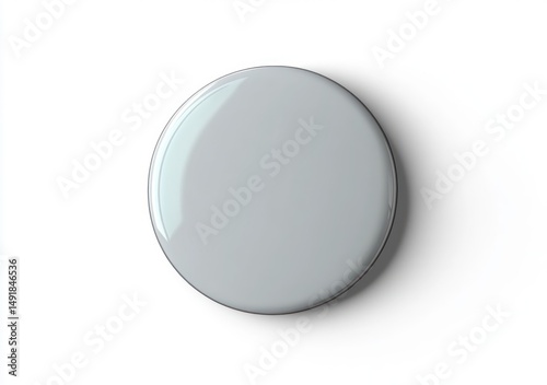 top view of a smooth round gray button or knob with a subtle shadow on a white background