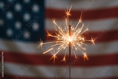 Celebratory sparkler glowing brightly against american flag in background