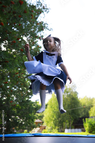 Children in school uniforms walk on the street. Children rejoice and have fun at the end of the school year. Holidays.