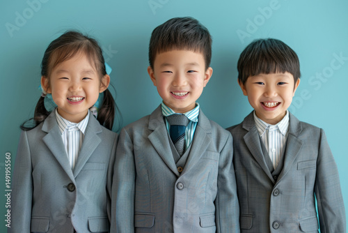 Group of young boys and girls in business suits, smiling confidently in a corporate themed setting. Their outfits and expressions reflect a professional, polished look.