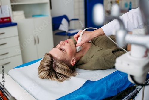 Female patient undergoing thyroid ultrasound examination