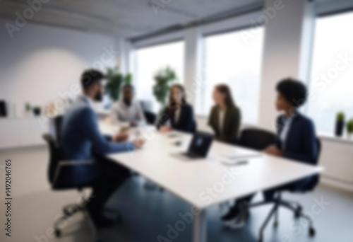 having a meeting in a blurry office, the atmosphere of a group of people having a meeting in a natural-themed, modern office with a wooden table, with a blurry office background