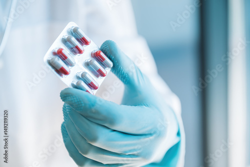 Doctor holding antibiotic medication pills blister in hands