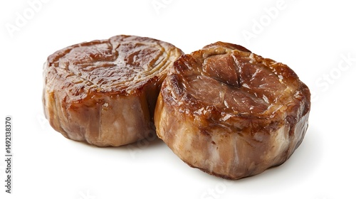 Photograph of two glazed brioche pastries, browned and textured, resting on a white surface. photo