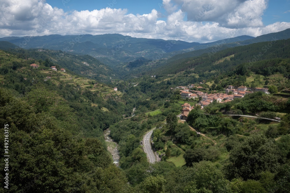 Fototapeta premium Lush Green Valley with Hidden Rural Village