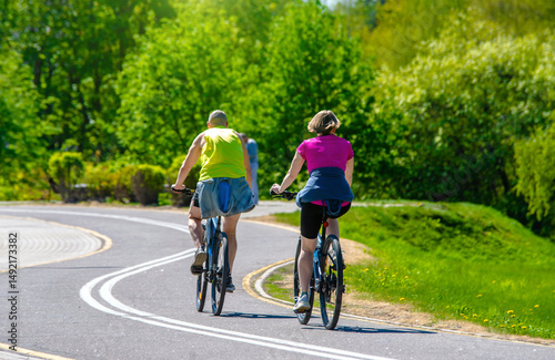 Wallpaper Mural Cyclists ride on the bike path in the city Park
 Torontodigital.ca