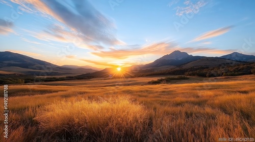 Majestic sunset illuminates rolling hills and golden grassland in a serene mountain landscape Generative AI
