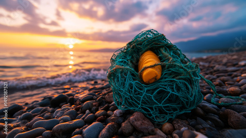 Sunlit Coastal Scene with Fishing Net and Buoy on Rocky Shore at Sunset