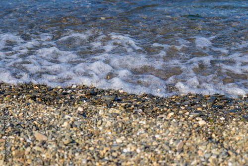 Fototapeta Naklejka Na Ścianę i Meble -  view of small foaming waves on the coastline in Izmir Park in Turkey