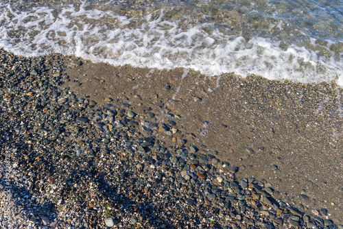 Fototapeta Naklejka Na Ścianę i Meble -  view of small foaming waves on the coastline in Izmir Park in Turkey