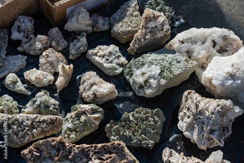 Collection of various uncut gemstones on a table. Close up of minerals.