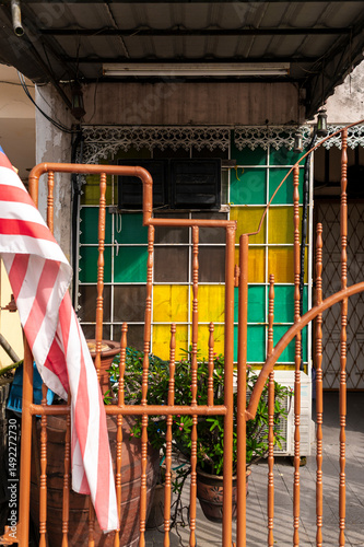 Yellow and green glass wall color pattern and brown entrance gate with Malaysian flag, Malaysia