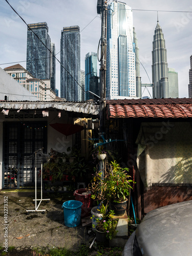 Dense plants and bucket under downtown skyline, Kuala Lumpur, Malaysia