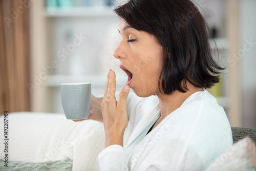 tired lazy woman having breakfast at home