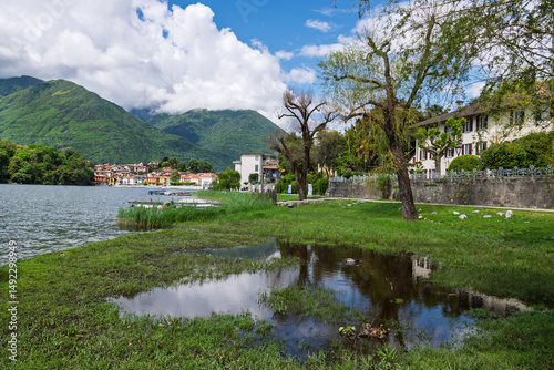 Canvas Print Scenic views of Mergozzo, a quaint village on Lake Mergozzo near Lake Maggiore, with boats on the calm water, stone houses, and peaceful lakeside charm