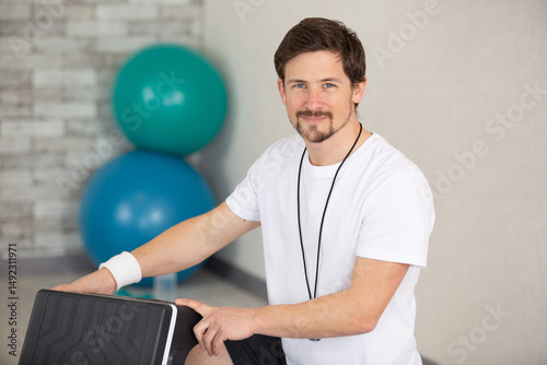 portrait of sportsman holding step workout equipment photo