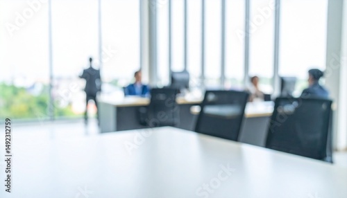 A softly blurred office interior with neutral tones and open-plan desks creates a clean, modern corporate atmosphere. Natural light streams through large windows.
