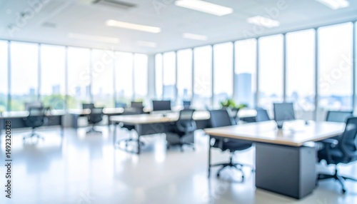 A softly blurred office interior with neutral tones and open-plan desks creates a clean, modern corporate atmosphere. Natural light streams through large windows.