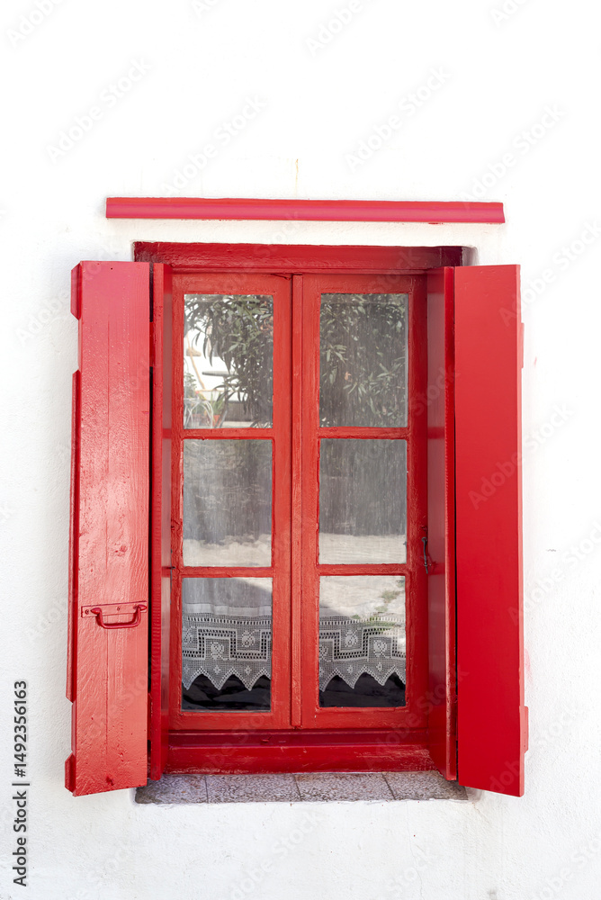 Obraz premium The background old white stony wall with a red window